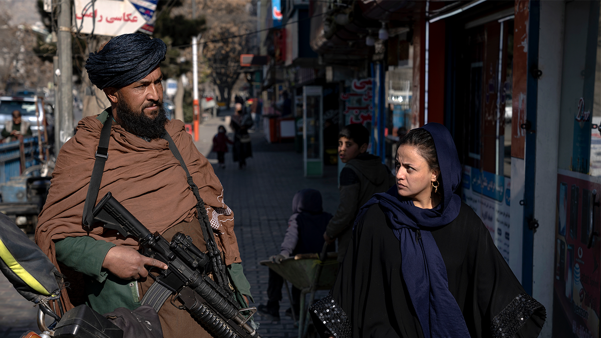 Taliban fighter and Afghan woman