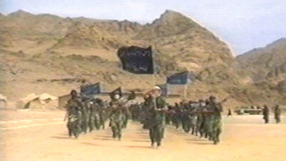 Terrorists participate in military training in this undated still frame from a recruitment video for Usama Bin Laden''s extremist Al Qaeda network.