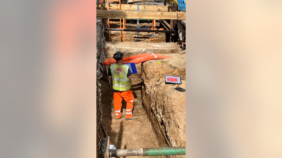 Archaeologist standing where ancient Roman road was found in London