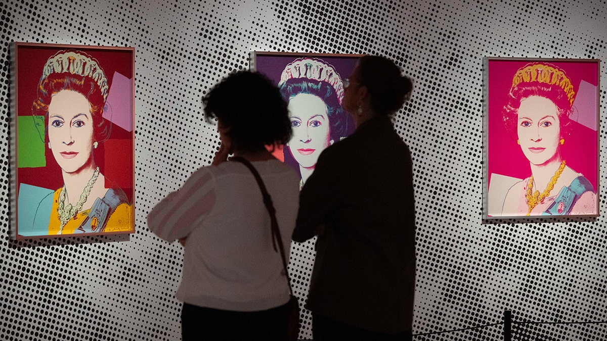 People look at Queen Elizabeth II Warhol portrait