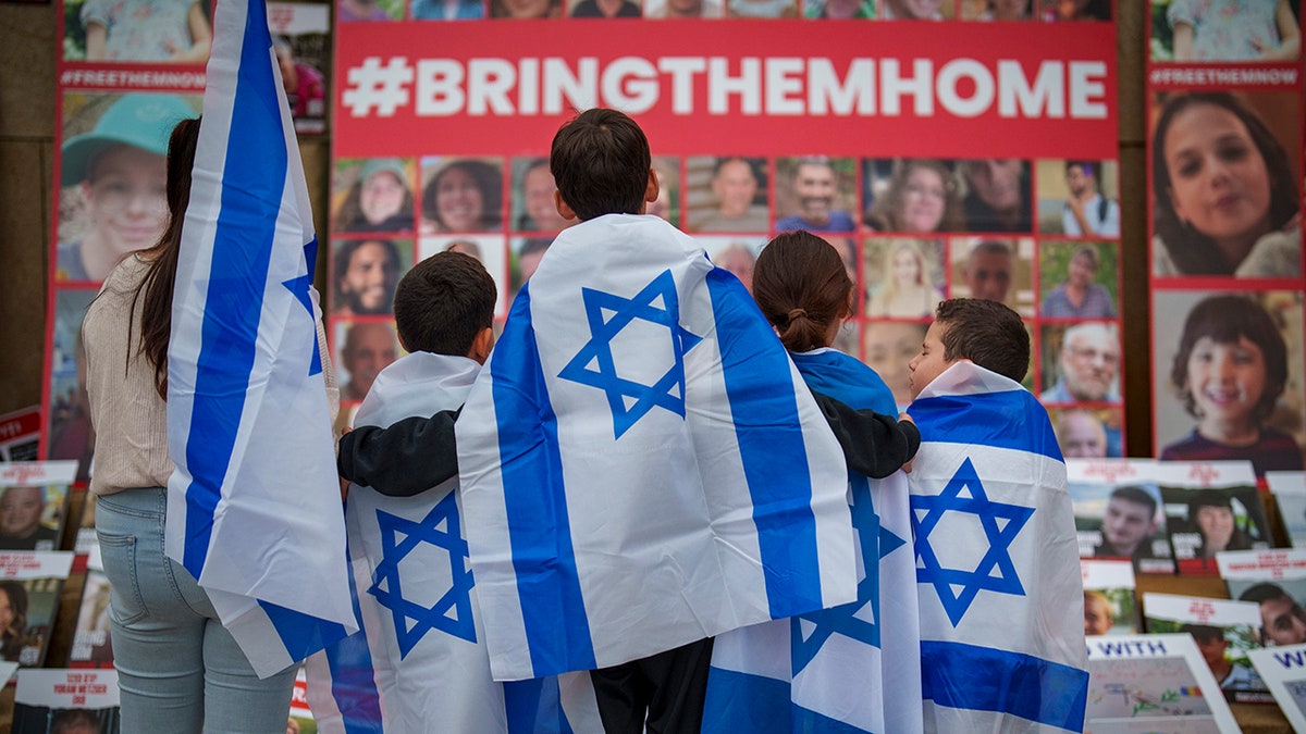 Children look at photographs of kidnapped