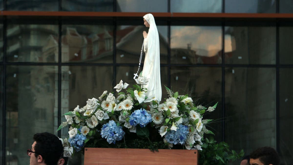 Lebanese Christian Syriac Catholic scouts carry a statue of the Virgin Mary during a procession marking the month of the Virgin Mary in a Christian dominated neighbourhood of Beirut on May 27, 2016. The Syriac Catholic Church belongs to the See of Antioch and extends it roots back to the origins of Christianity in the Levant.