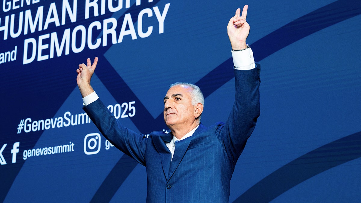 Reza Pahlavi waves to a crowd in Geneva 