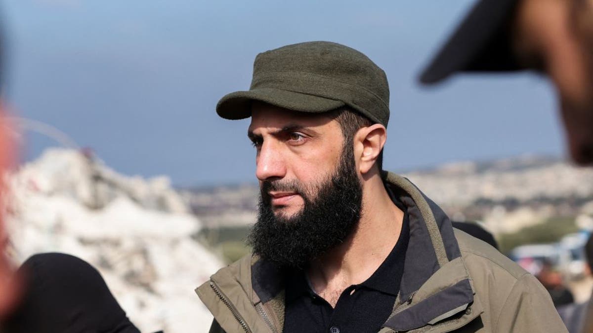 Hayat Tahrir al-Sham (HTS) jihadist group's chief Abu Mohamed al-Jolani checks the damage following an earthquake in the village of Besnaya in Syria's rebel-held northwestern Idlib province at the border with Turkey, on February 7, 2023. 