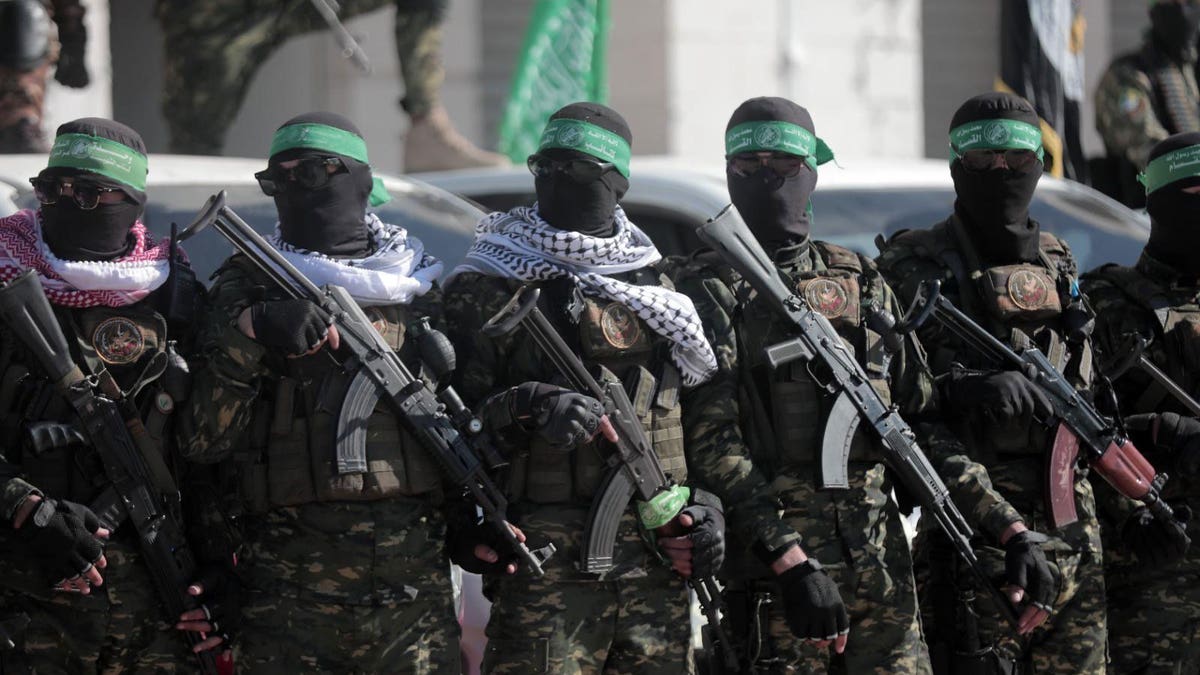 Hamas militants holding guns.