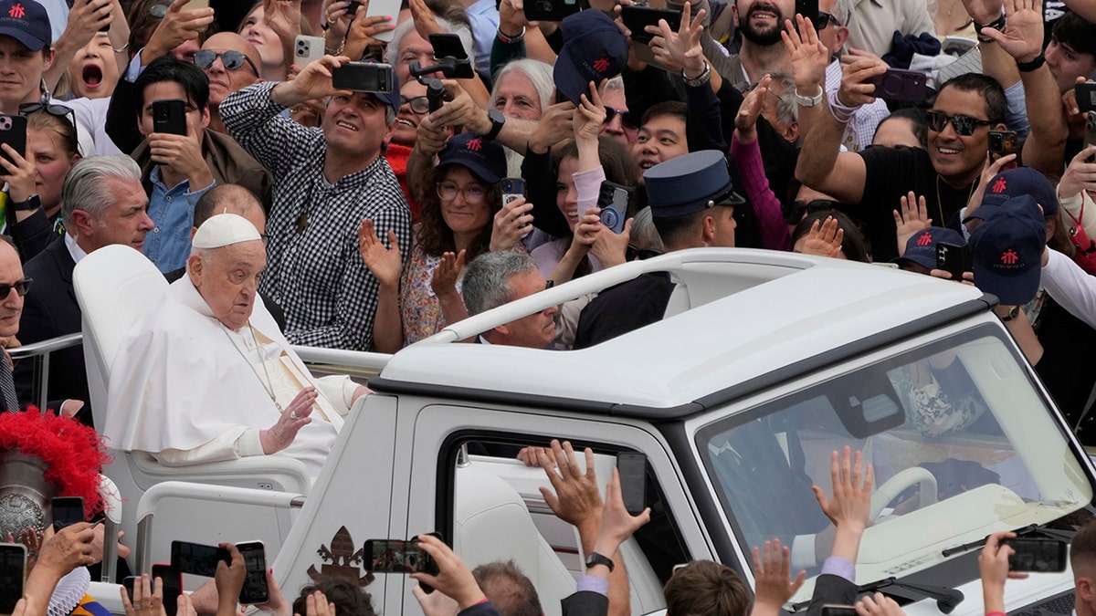 Pope Francis touring in popemobile
