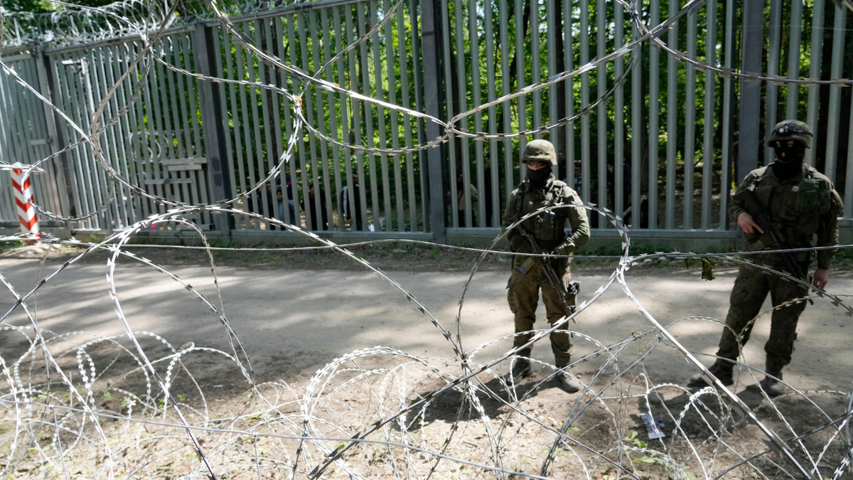Polish troops guard the metal barrier border with Belarus, in Bialowieza Forest, on Wednesday, May 29, 2024. Poland says neighboring Belarus and its main supporter Russia are behind a surging push by migrants in Belarus toward the European Union.
