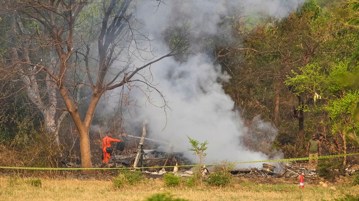 Smoke rises from downed aircraft in India