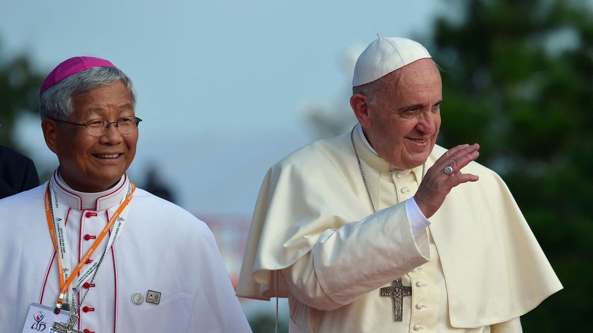 Pope Francis, right, walks with the Bishop of Daejon, Lazarus You Heung-sik