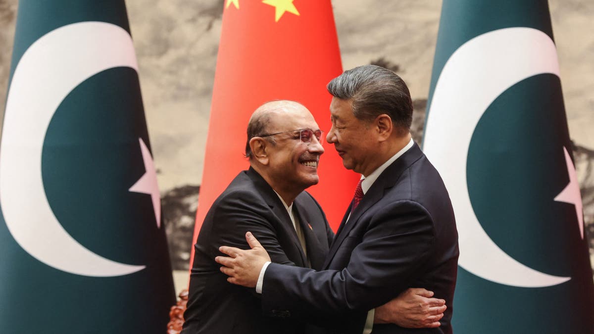 Chinese President Xi Jinping, right, hugs Pakistani President Asif Ali Zardari