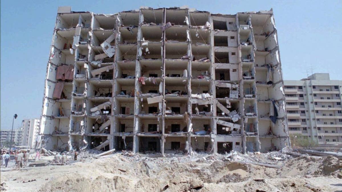 Destroyed Khobar Towers and crater where a truck bomb exploded at a U.S military complex in Saudi Arabia