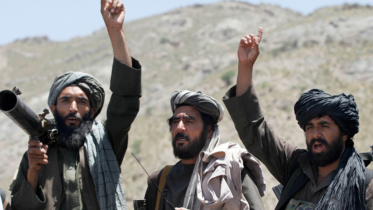 FILE - In this May 27, 2016 file photo, Taliban fighters react to a speech by their senior leader in the Shindand district of Herat province, Afghanistan. After operating out of Pakistan for more than a decade, the leaders of Afghanistans Taliban movement may have moved back to their homeland to try to build on this years gains in the war and to establish a permanent presence. If confirmed, the move would be a sign of the Talibans confidence in their fight against the U.S.-backed government in Kabul. (AP Photos/Allauddin Khan, File)
