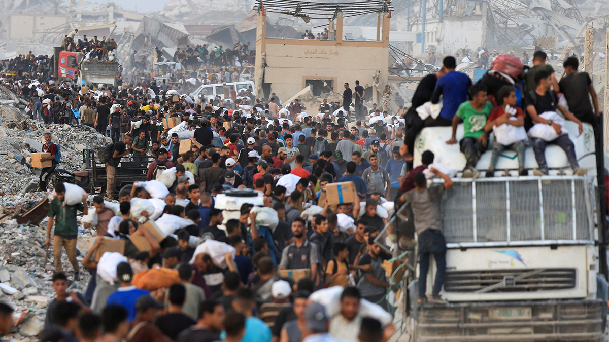 Palestinians carry aid supplies