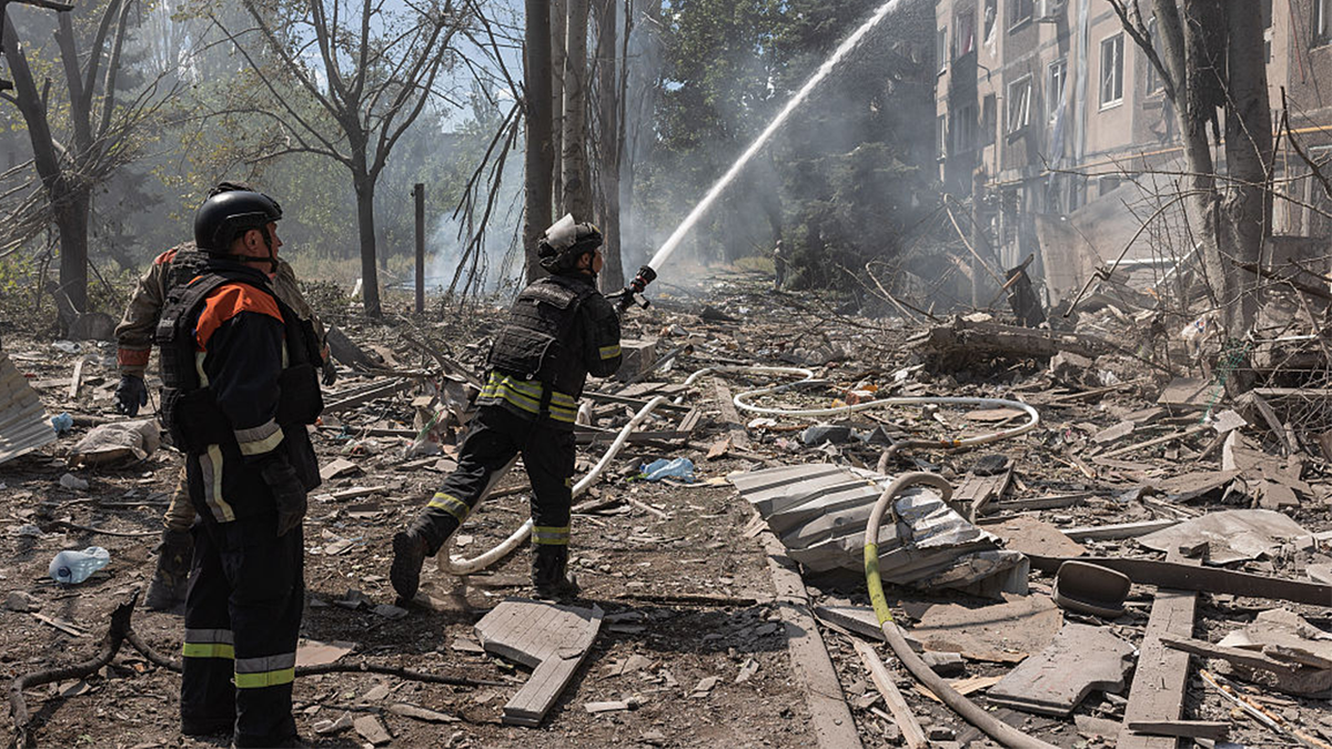 Ukrainian firefighters search for survivors after a Russian air strike on a residential building