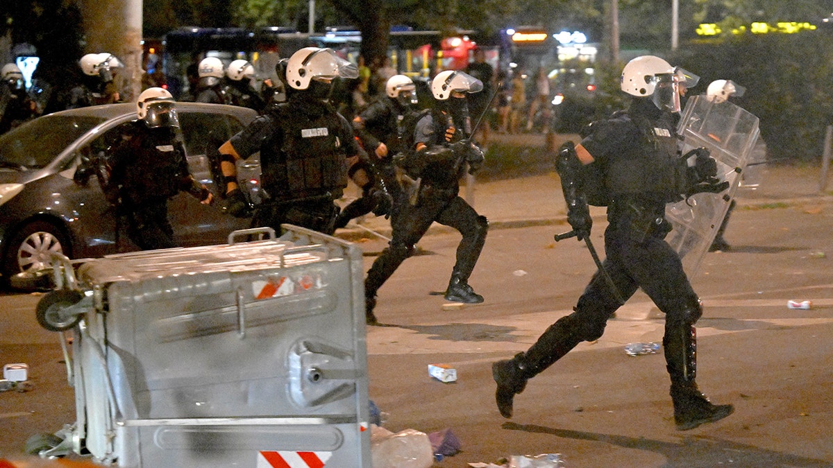 Serbian riot police clashes with anti-government protesters in Belgrade on August 13, 2025. . 
