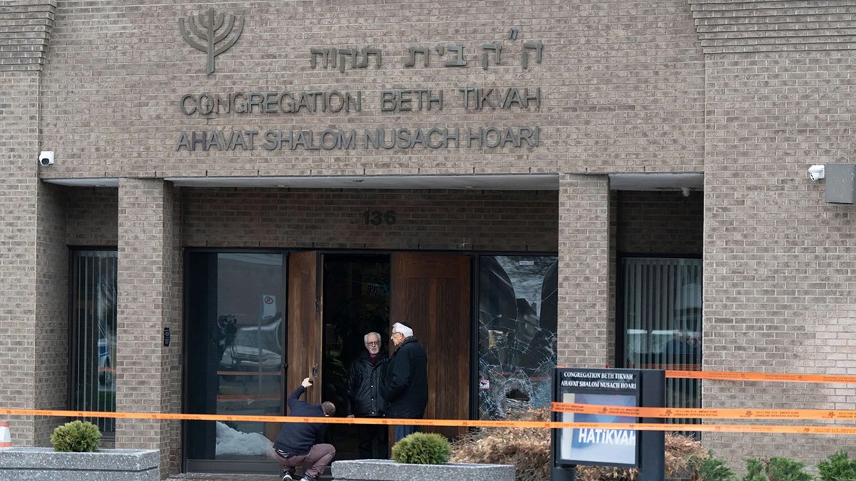 A man fixes the lock of the doors of Congregation Beth Tikvah as police investigate an alleged arson at the synagogue in the suburb of Dollard-des-Ormeaux in Montreal on Wednesday, Dec. 18, 2024.