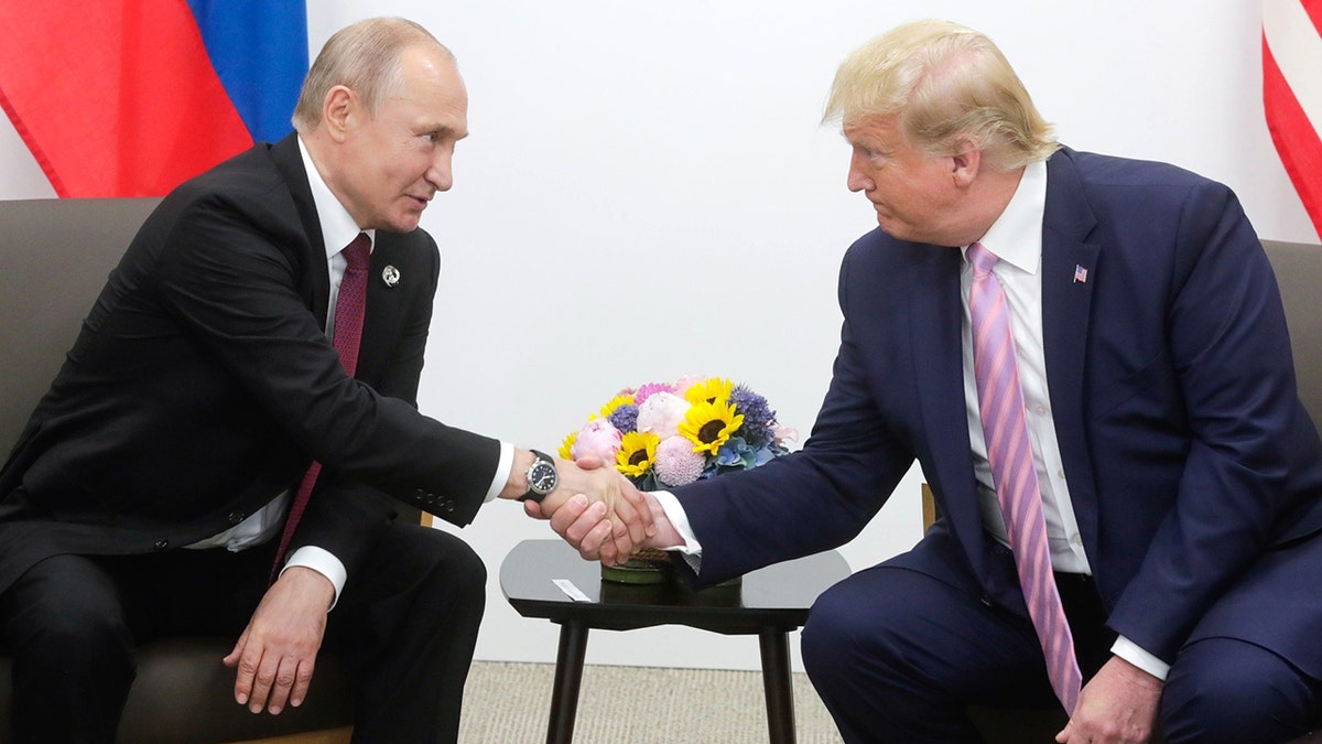 Trump and Putin shake hands