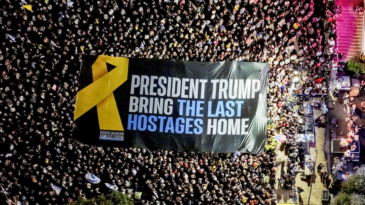 Protesters in Tel Aviv hold sign reading "President Trump Bring the Last Hostages Home"