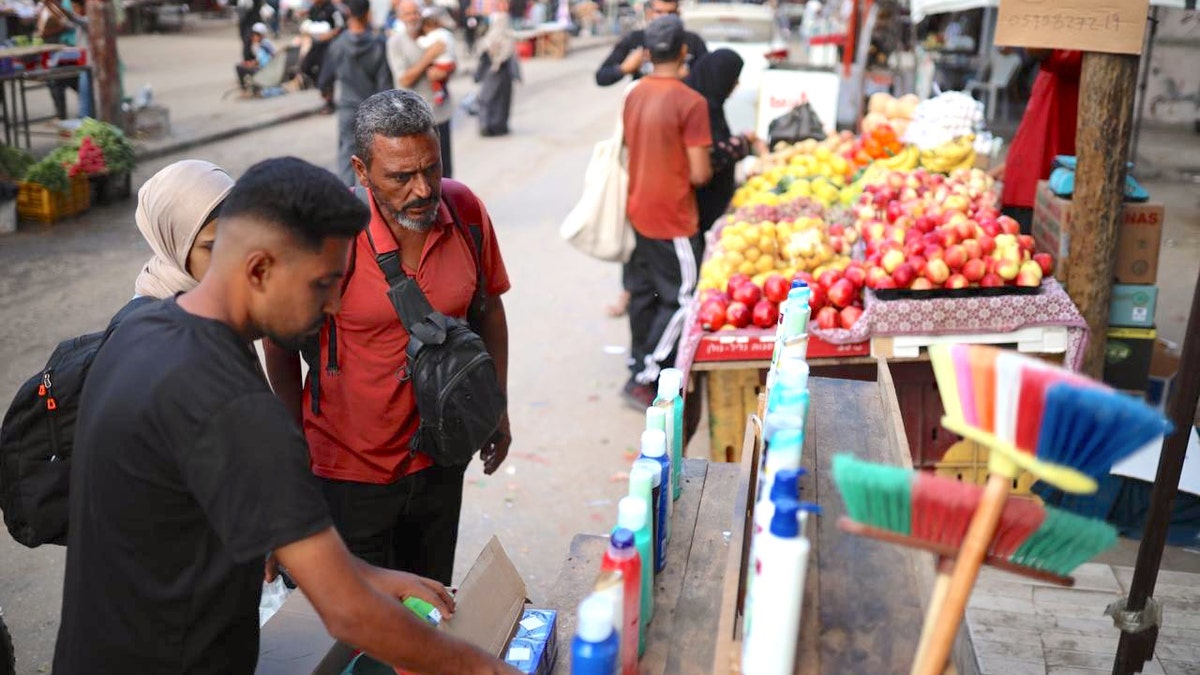 People shop at a market in central Gaza