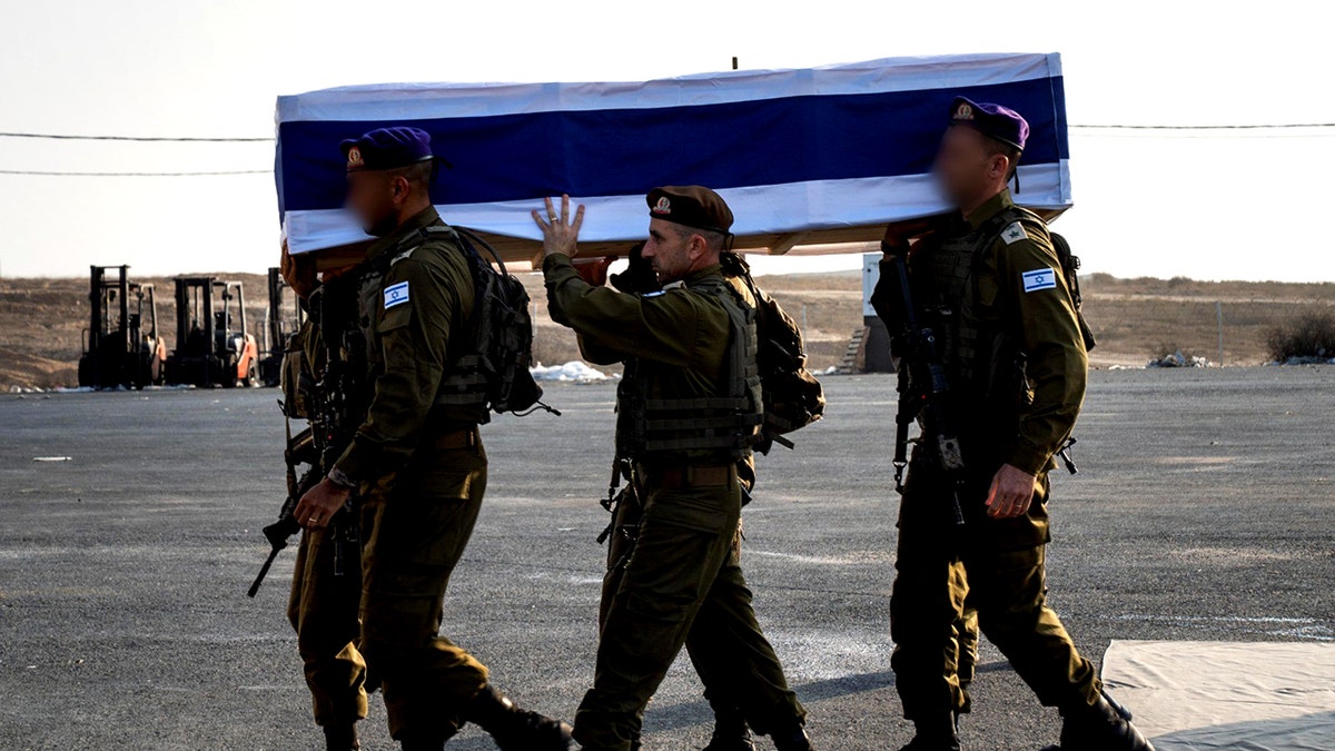 IDF soldiers carrying coffin with remains of Hadar Goldin
