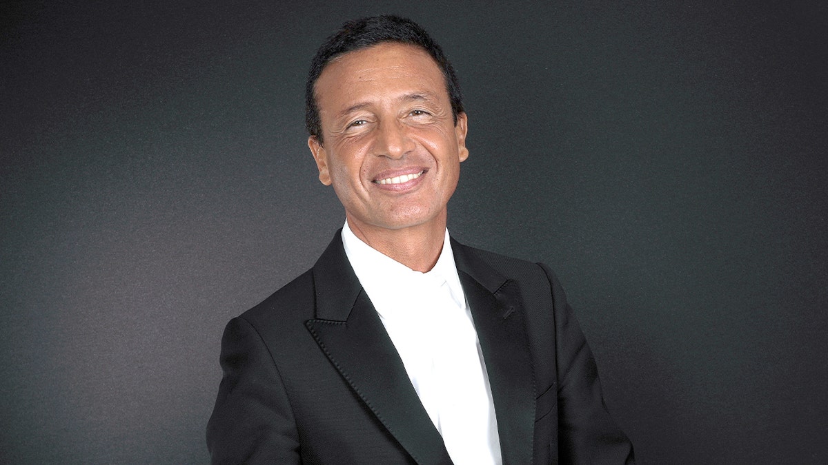 Omar Harfouch poses confidently for a portrait session in Paris.