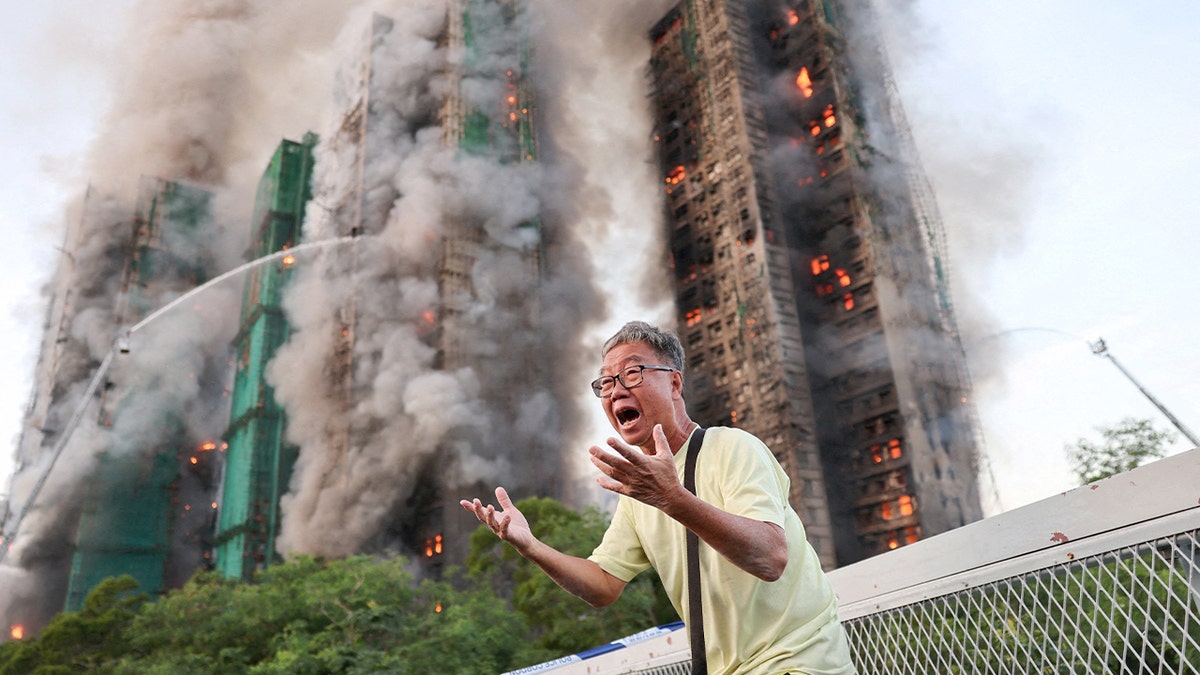 An elderly man breaks down in distress near an active fire scene.
