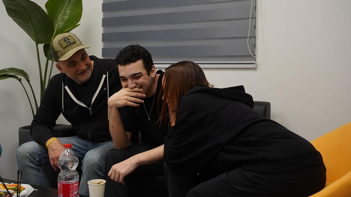Edan Alexander speaks with loved ones following his release.