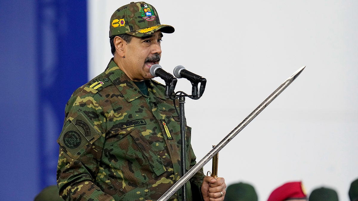 Nicolás Maduro waves a sword during speech