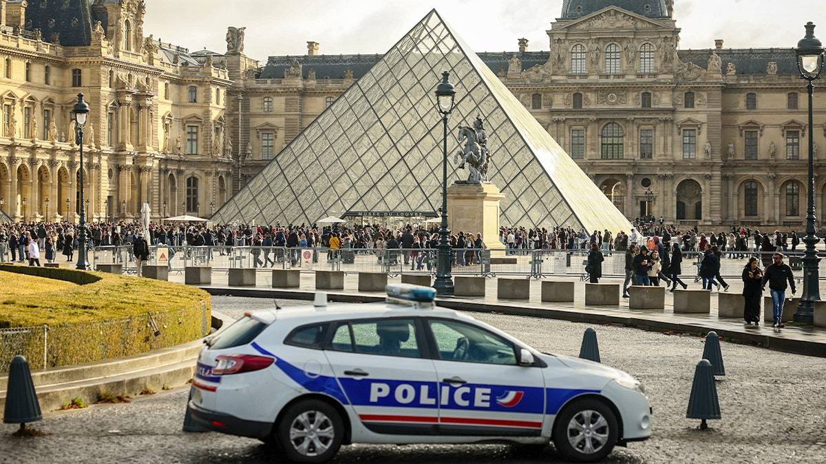 Police car in front of the Louvre Museum