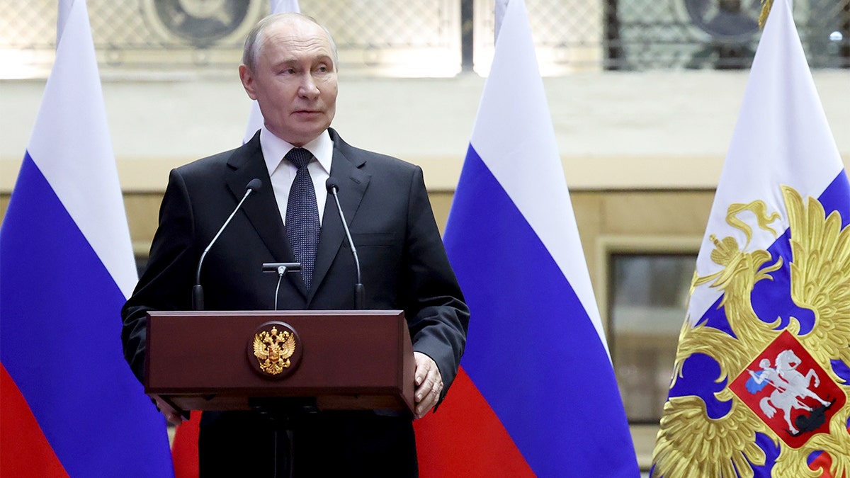 Vladimir Putin delivers remarks at a medal presentation ceremony following a military briefing.