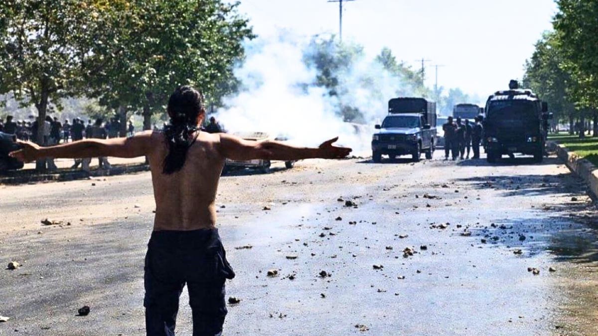 A protester faces Iranian security forces during clashes amid nationwide unrest, according to images released by the Iranian opposition group National Council of Resistance of Iran (NCRI).