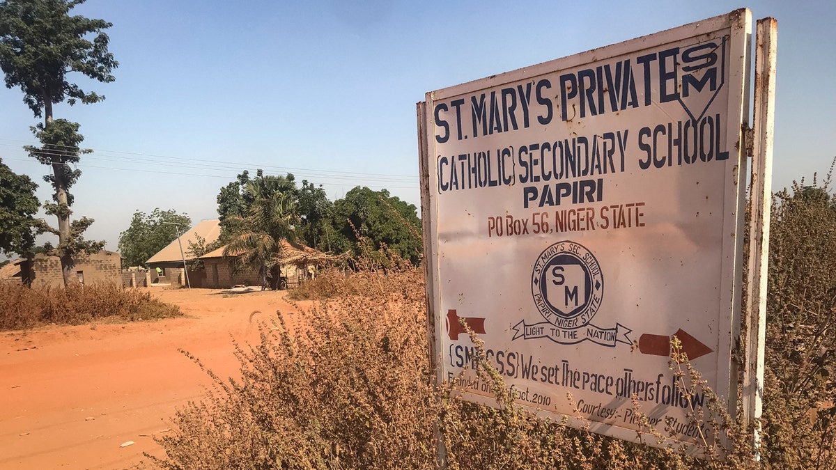 School entrance marker identifies a Catholic secondary school in a rural Nigerian community.