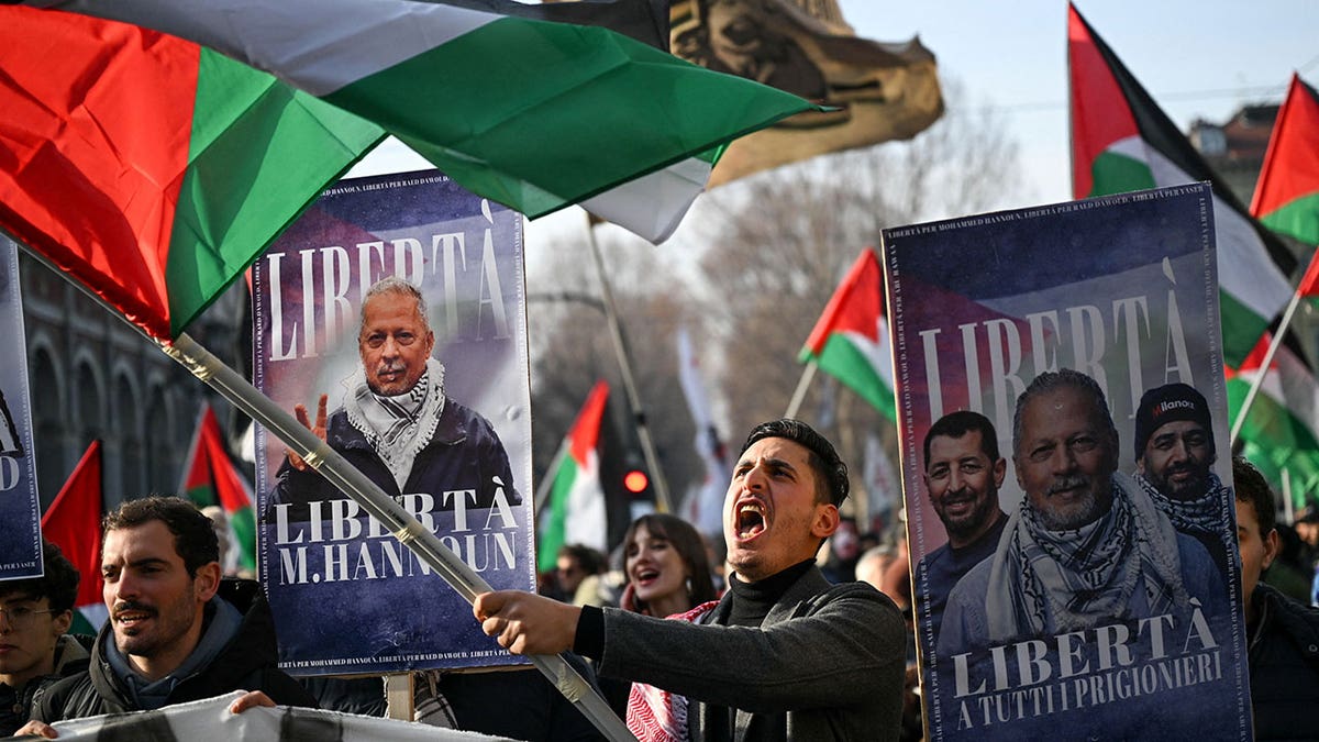 Demonstrators wave Palestinian flags and hold banners depicting Mohammad Hannoun, president of the Palestinian Association in Italy, who was arrested by Italian authorities over alleged funding of Hamas through charities, during a march in support of the Askatasuna social centre in Turin, Italy