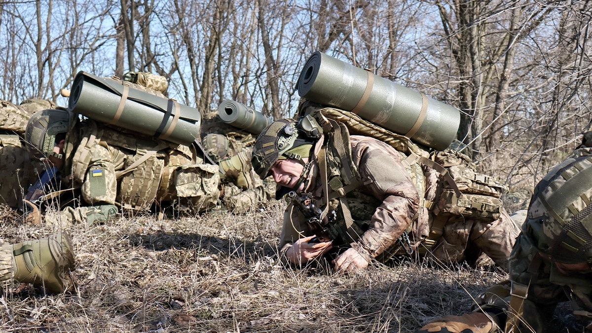 Ukrainian army recruits take part in field exercises during initial training near the front line in the Zaporizhzhia region.