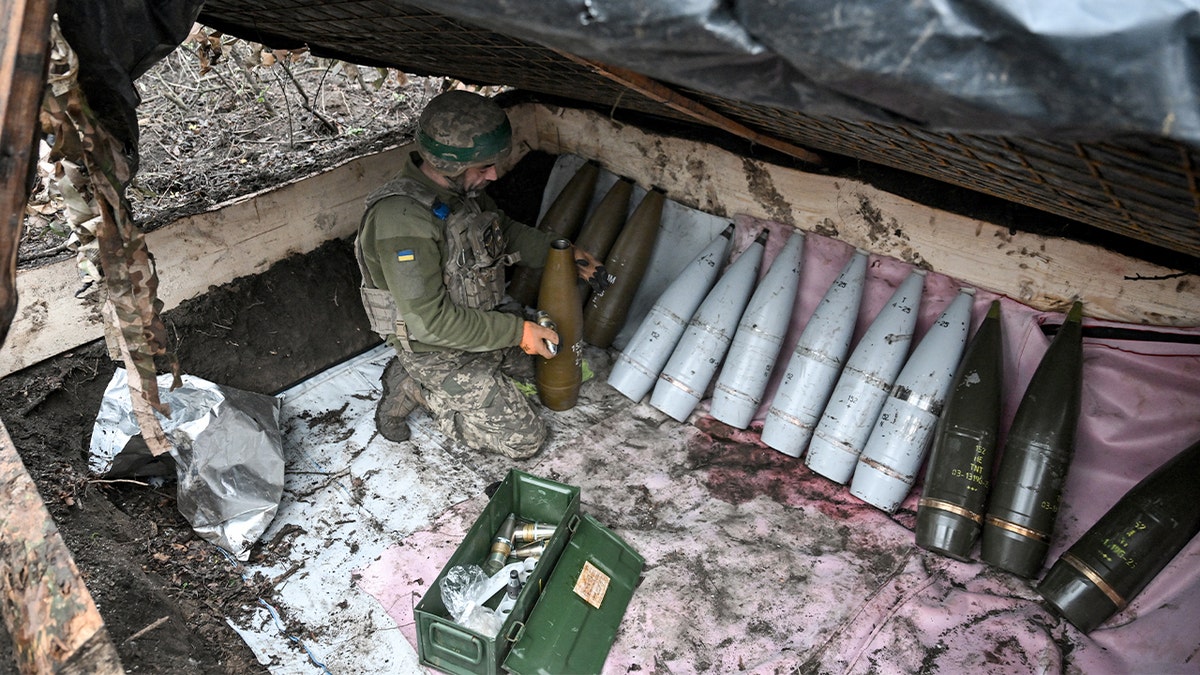 Ukrainian artillery soldier prepares ammunition by fitting fuses during a deployment in the Donetsk region.