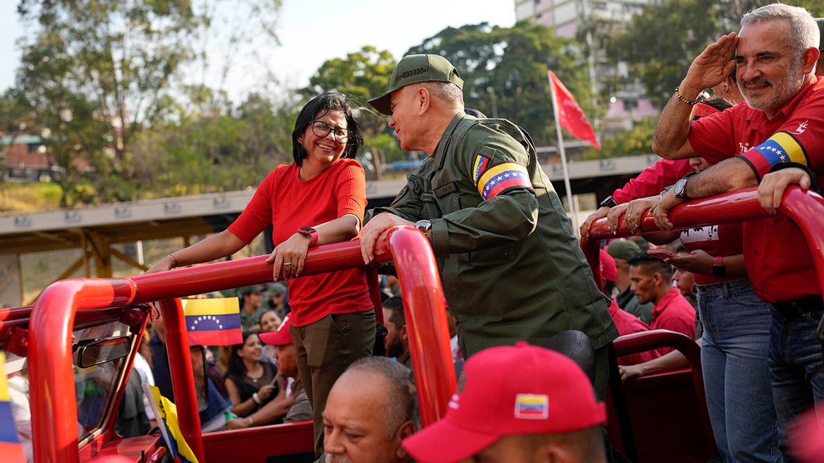 Vice President Delcy Rodriguez, left, smiles at Defense Minister Vladimir Padrino Lopez.