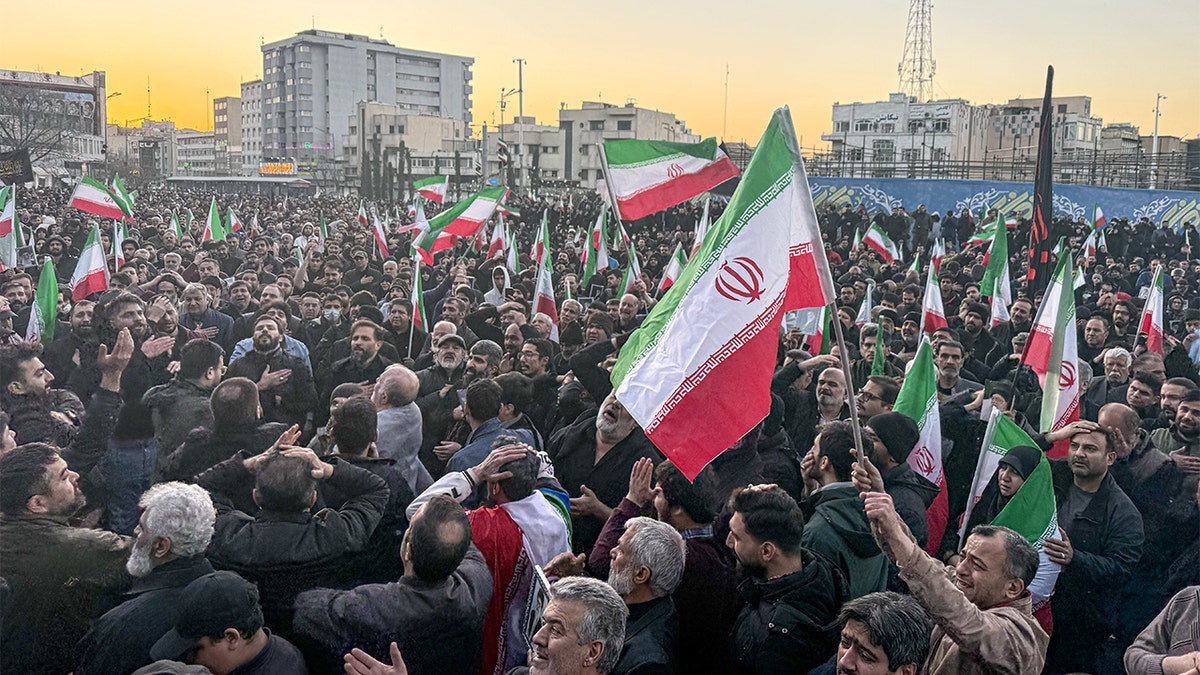 Thousands of people gather in a central Tehran square following a major announcement broadcast on state television.