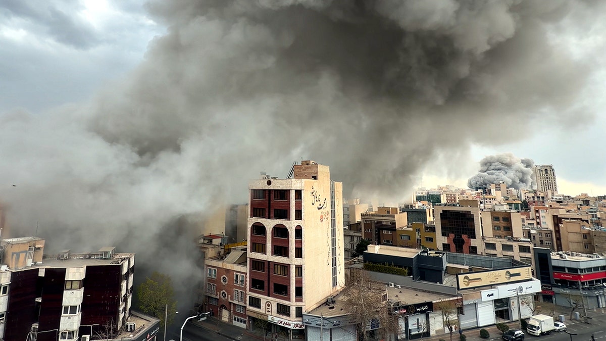 Plumes of smoke rising over city