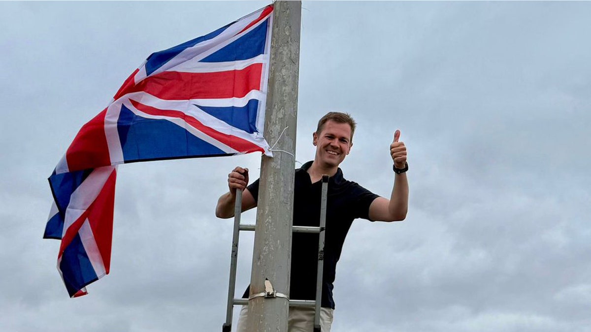 MP Robert Jenrick posing with Union Jack