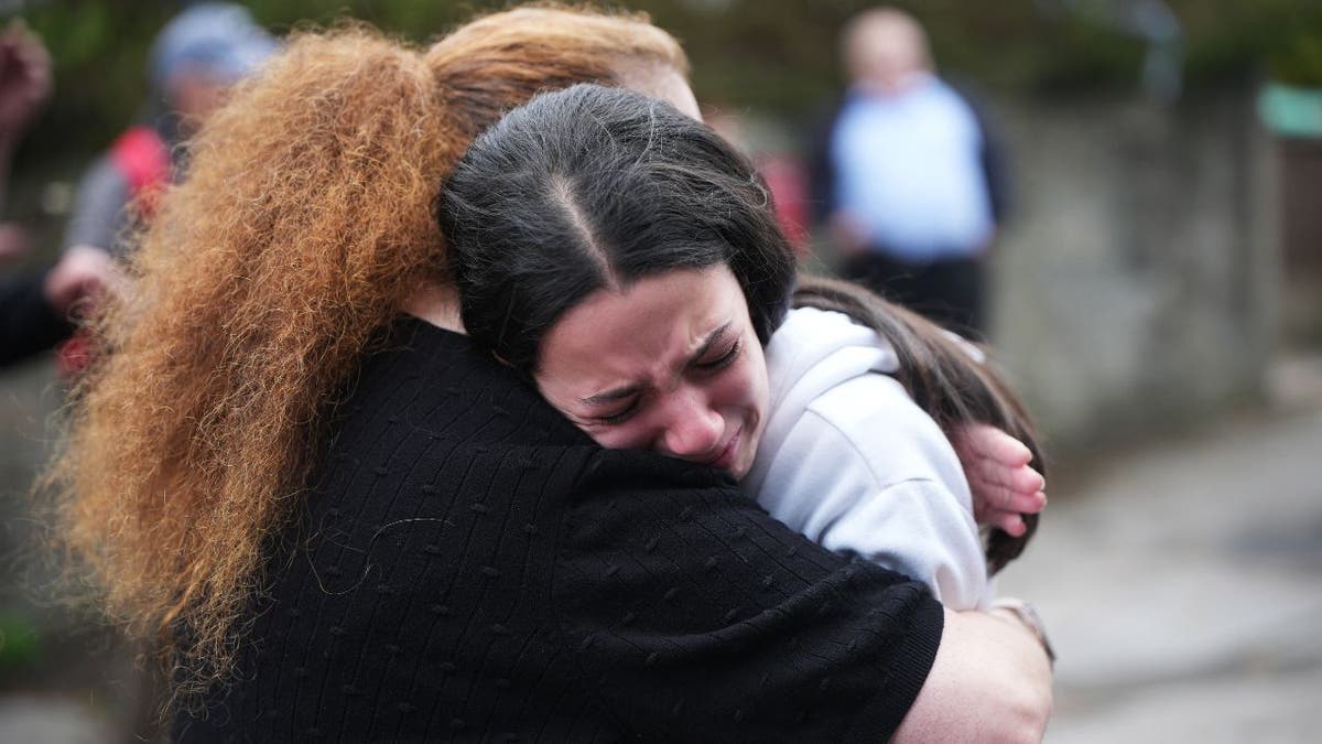 Mourners embrace after Manchester synagogue terror attack