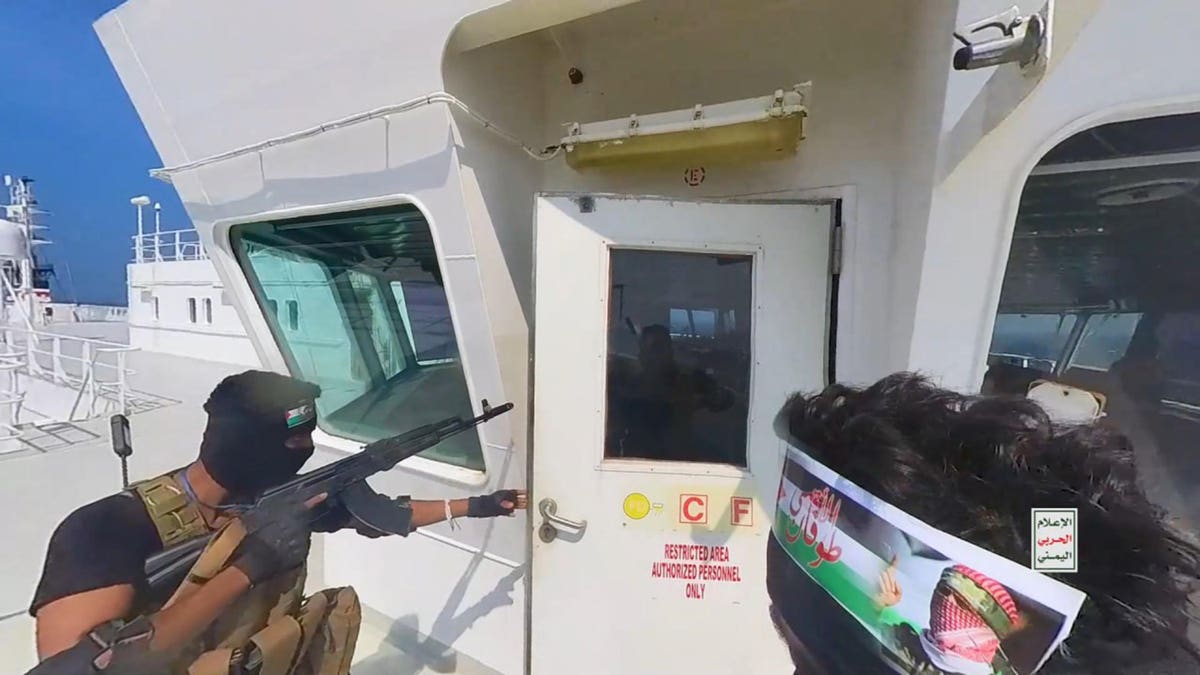 Houthi fighters taking control of the Galaxy Leader Cargo ship off Hudaydah Yemen