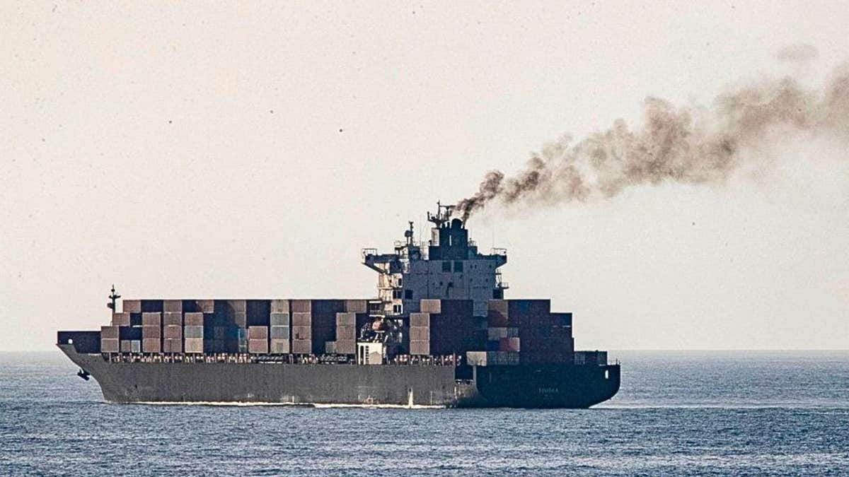 The Iranian-flagged Touska cargo ship pours smoke out of its engine room