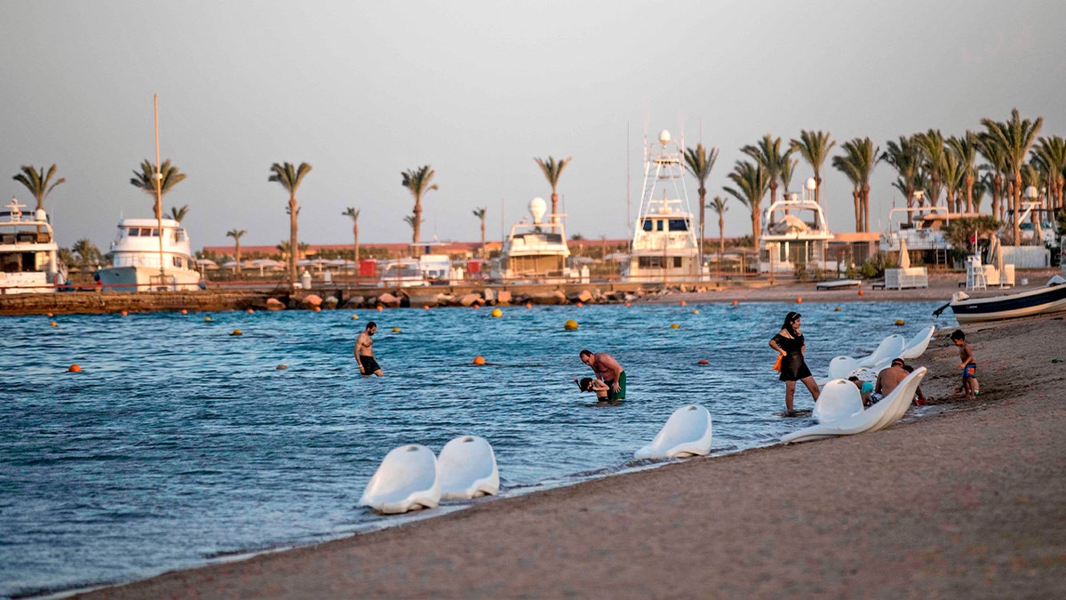 people swimming at beach