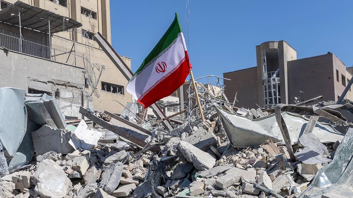 Iranian flag on pile of rubble