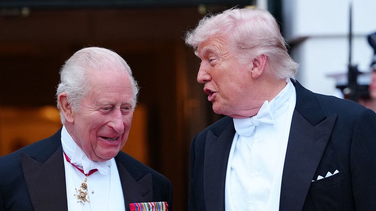 US President Donald Trump speaking with Britain's King Charles III in the White House East Room