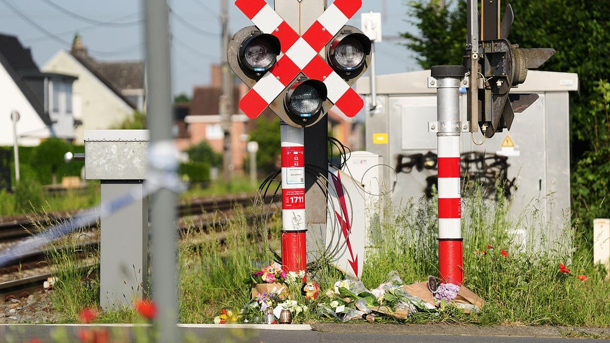 Flower condolences left at a level crossing in Buggenhout, Belgium