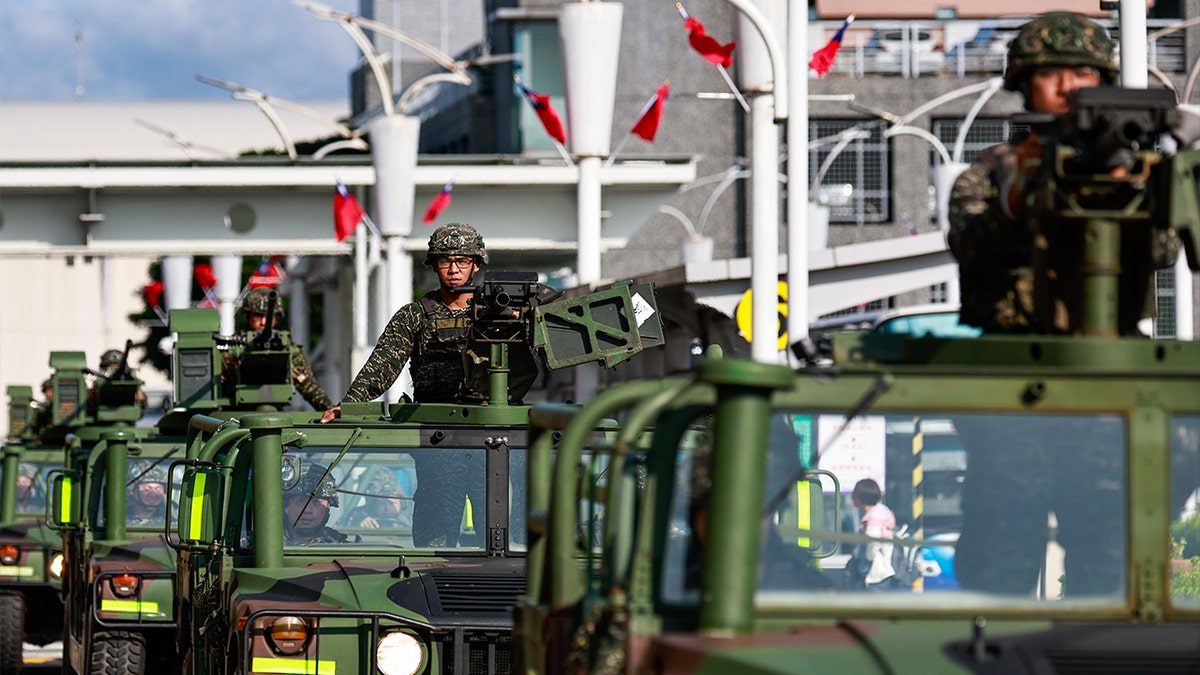 A procession of Taiwanese armed military vehicles patrolling outside Songshan Airport in Taipei
