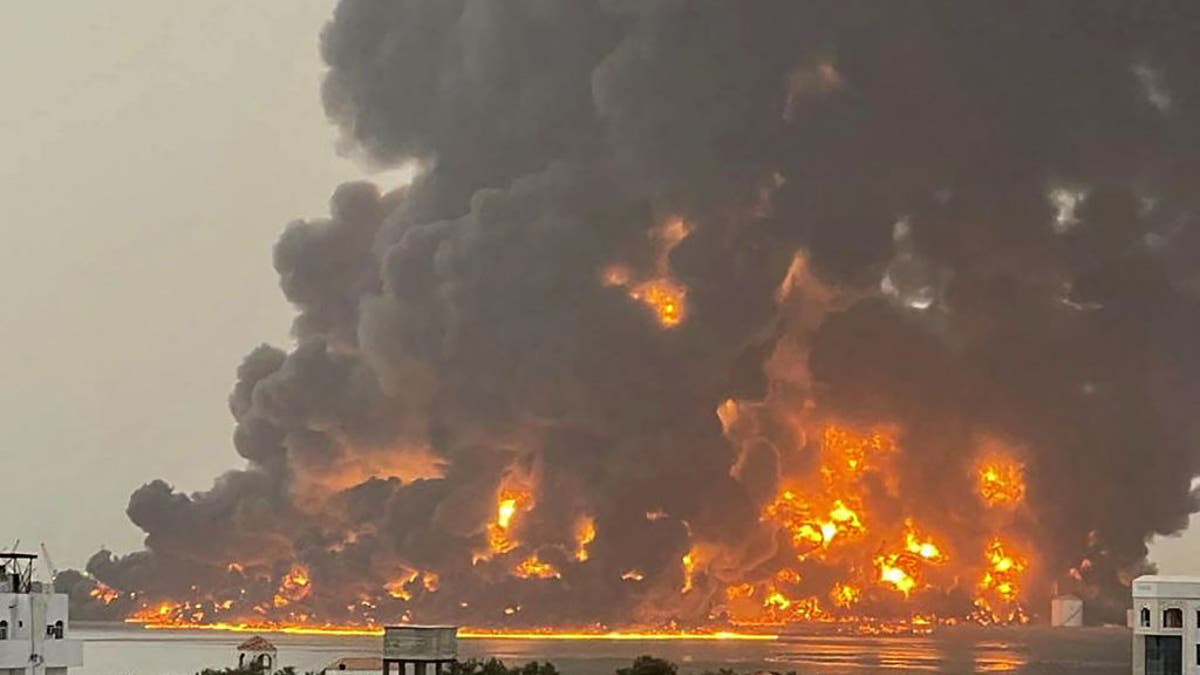 A huge column of fire erupts in the Yemeni port city of Hodeida after reported strikes