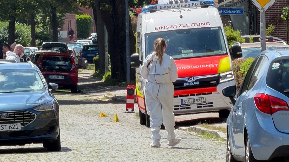 A member of emergency services working at a shooting scene in Stade, Germany.