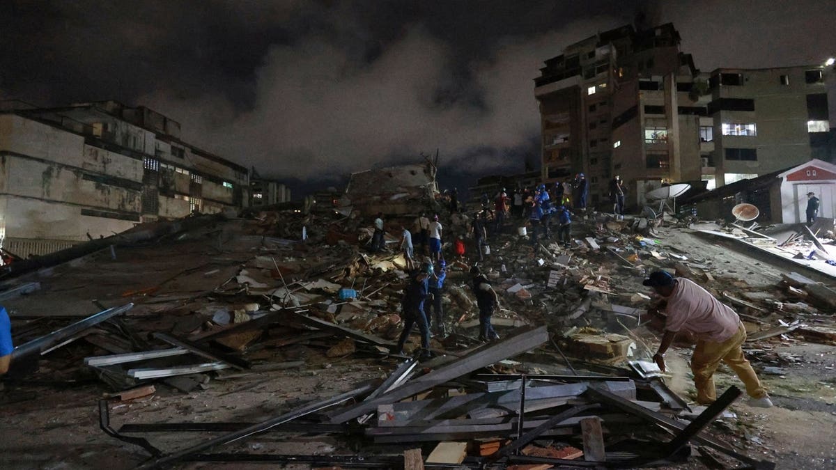 Rescue workers search through the rubble after an earthquake in Caracas, Venezuela, Wednesday, June 24, 2026.